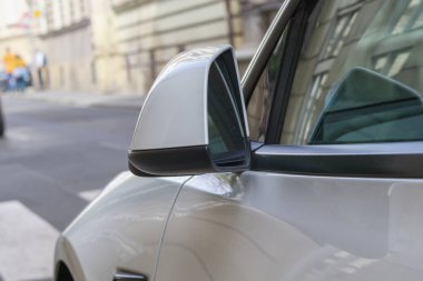 view of the side mirror of a white car clipart