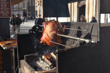 Büyük bir parça et, belki domuz budu ya da jambon, açık ateşte ya da ızgarada kızartılmış..