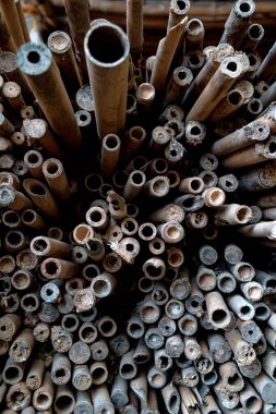 A large pile of small bamboo, which will later be made into various crafts such as children's toys, straws, flutes, and others, the production process is done manually by local craftsmen