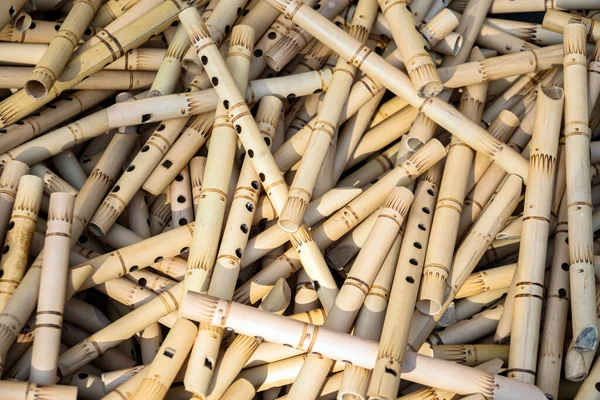 Pile of half-finished bamboo flutes, handmade bamboo flute production process by craftsmen, bamboo flutes being dried before finishing and marketed