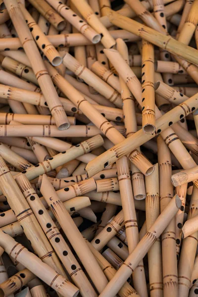 Pile of half-finished bamboo flutes, handmade bamboo flute production process by craftsmen, bamboo flutes being dried before finishing and marketed