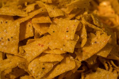Tortilla chips served in a bamboo basket with a flat lay concept, the tortilla chips are fried golden yellow and very crunchy