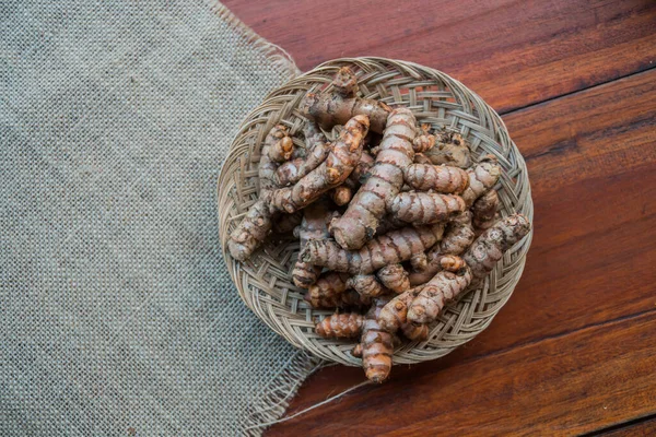 Traditional herbal ingredients of empon empon or root plants that are good for health and treatment in a bamboo basket, including turmeric, ginger, temulawak, galangal, wedang uwuh, and others