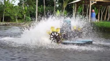 Waterwheel in red tilapia fish farming pond. Waterwheel system to circulate water and oxygen in artificial ponds, so that fish are healthier and the water remains clear