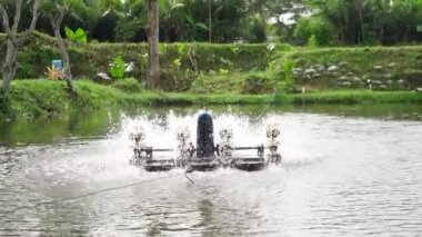 Waterwheel in red tilapia fish farming pond. Waterwheel system to circulate water and oxygen in artificial ponds, so that fish are healthier and the water remains clear