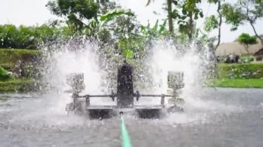 Waterwheel in red tilapia fish farming pond. Waterwheel system to circulate water and oxygen in artificial ponds, so that fish are healthier and the water remains clear