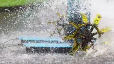 Waterwheel in red tilapia fish farming pond. Waterwheel system to circulate water and oxygen in artificial ponds, so that fish are healthier and the water remains clear
