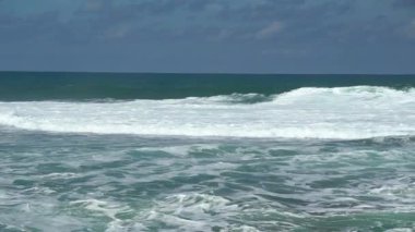 Amazing coast with rolling waves in Gunung Kidul, Indonesia. This exotic beach has good waves and amazing natural scenery