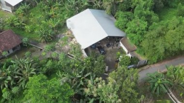 Alt bölgedeki bir atık işleme alanının hava görüntüleri, ev ve küçük ölçekli endüstriyel atıklar için toplama alanı olarak kullanılan bir binanın yavaş çekim drone görüntüleri.