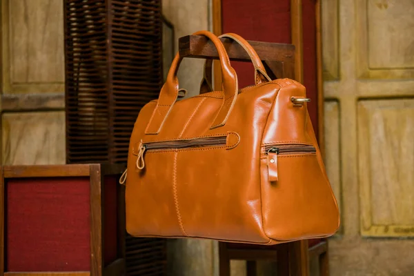 Display of handmade women's genuine leather bags made by craftsmen in Indonesia. Various types of very fashionable women's bags with nice details and various color and motif variants