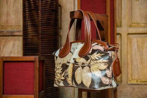 Display of leather bags for women made by craftsmen in Indonesia. Various types of detailed and beautiful women\'s bags are combined with eco print artwork with leaf and flower motifs