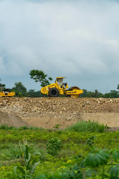 The location for the construction of a toll road connecting the two cities. There are excavators, compactors & dozers busy passing through the project area during the day