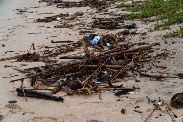 Plastic waste scattered and hit by sea waves. Marine pollution is caused by the use of single-use plastics that are thrown away carelessly, thereby damaging the environment, ecology and water.