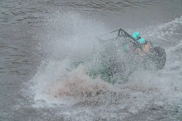 stock image Jeep tours take extreme and challenging routes by crossing rivers at high speed so that the air splashes in all directions and wets the passengers. At that time water splashes soared and wet the jeep and passengers