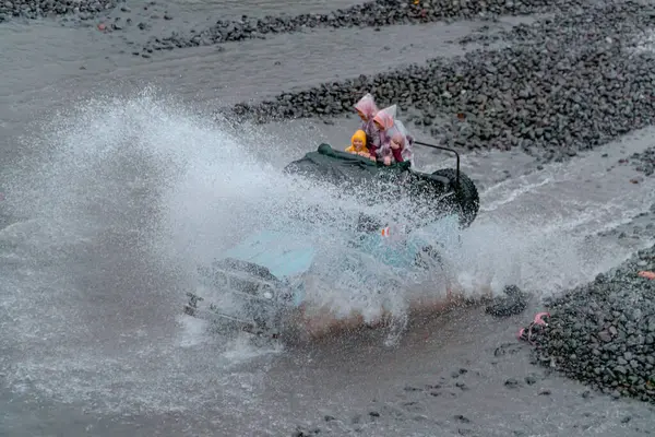 stock image Jeep tours take extreme and challenging routes by crossing rivers at high speed so that the air splashes in all directions and wets the passengers. At that time water splashes soared and wet the jeep and passengers