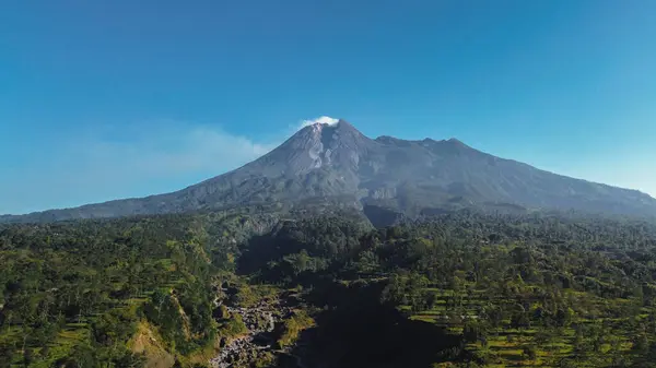 stock image Panorama of Mount Merapi with beautiful views in the morning in summer. Active volcano landscape in detail with forest and ravine in front