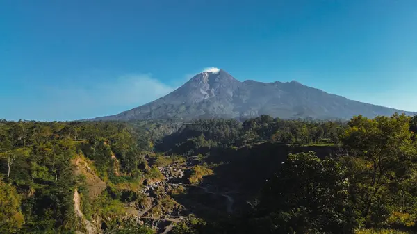 stock image Panorama of Mount Merapi with beautiful views in the morning in summer. Active volcano landscape in detail with forest and ravine in front