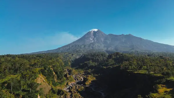 stock image Panorama of Mount Merapi with beautiful views in the morning in summer. Active volcano landscape in detail with forest and ravine in front