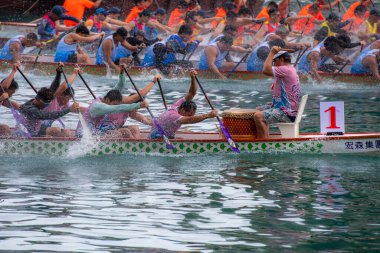 ABERDEEN HONG KONG,JUNE 10,2024: people racing the dragon boats festival race in aberdeen, hong kong clipart