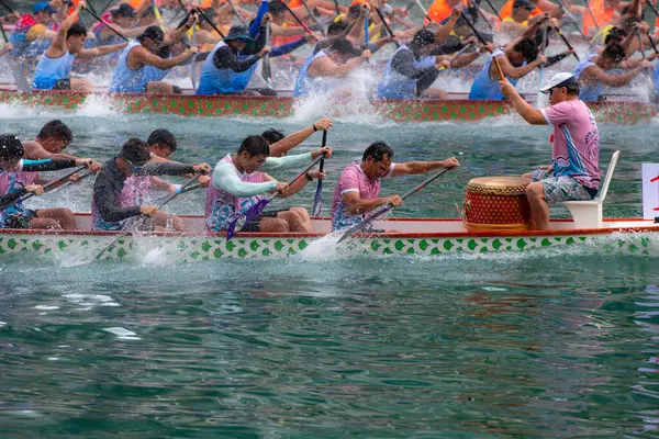 stock image ABERDEEN HONG KONG,JUNE 10,2024: people racing the dragon boats festival race in aberdeen, hong kong