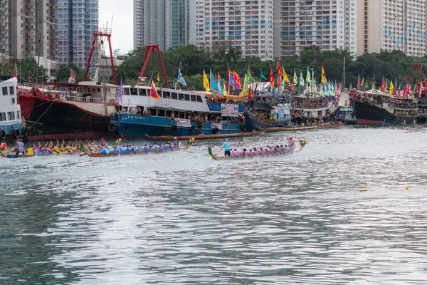 stock image ABERDEEN HONG KONG,JUNE 10,2024: people racing the dragon boats festival race in aberdeen, hong kong