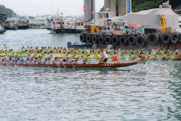 stock image ABERDEEN HONG KONG,JUNE 10,2024: people racing the dragon boats festival race in aberdeen, hong kong