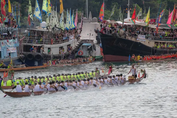 stock image ABERDEEN HONG KONG,JUNE 10,2024: people racing the dragon boats festival race in aberdeen, hong kong