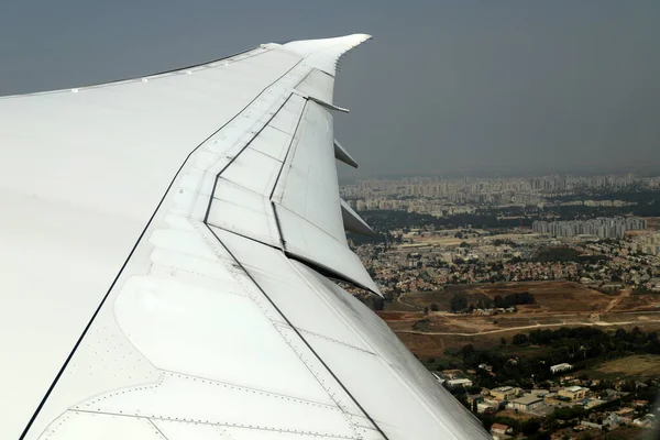 stock image The earth is seen through the porthole of a large jet plane.