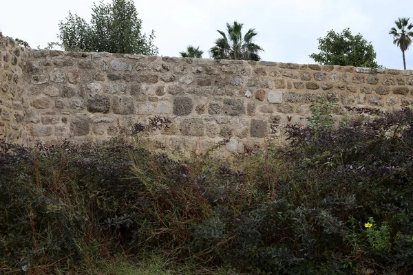 stock image Stone wall of an ancient fortress on the seashore in Israel.