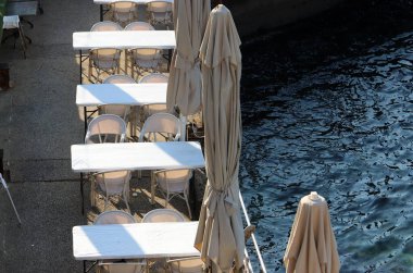 Chair and table in a cafe in a city park near the sea.