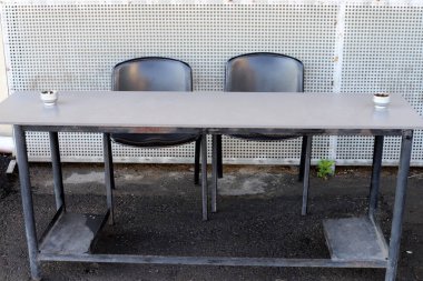 Chair and table in a cafe in a city park near the sea.