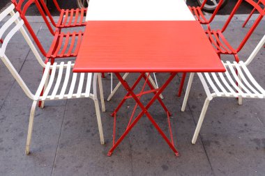Chair and table in a cafe in a city park near the sea.