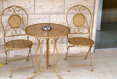 Chair and table in a cafe in a city park near the sea.