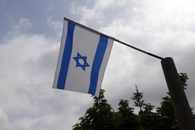 İsrail 'in mavi ve beyaz bayrağı Davut' un altı köşeli yıldızıyla.
