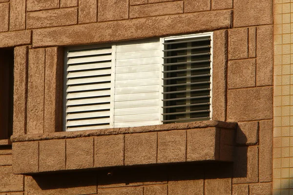 stock image A small window in an old one-story house.