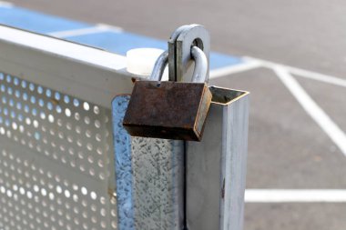 Kapıda eski bir asma kilit asılı.