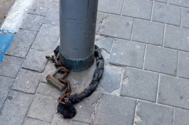 Çitte eski metal bir kilit asılı..