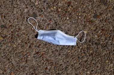 Coronavirus 'a karşı korunmak için bir yüz maskesi şehir parkında bulunur..