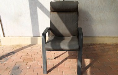 Büyük bir şehirde kaldırımda bir şezlong duruyor..