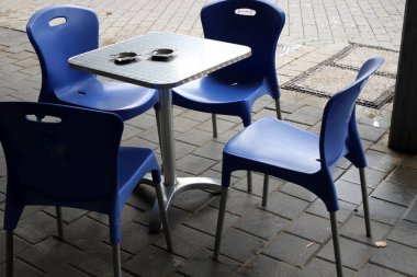 Sahildeki bir kafede sandalye ve masa.