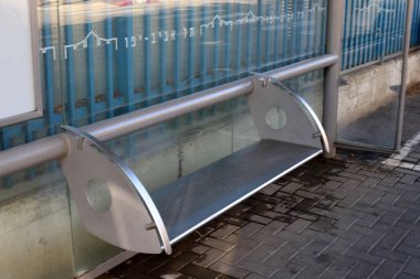 Deniz kıyısındaki bir şehir parkında rahatlamak için bir bank.