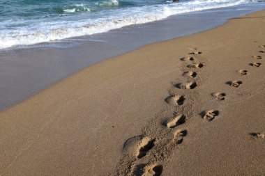 Footprints in the sand on the shores of the Mediterranean Sea.