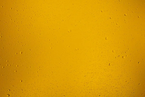 対照的な水滴でオレンジ色の透明背景を光る — ストック写真