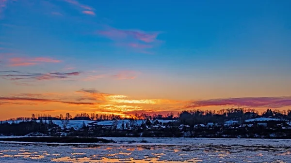 stock image Winter landscape. Sunset illuminates the river with floating ice floes. Toned photo.