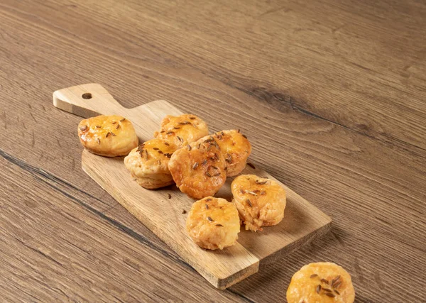 Stock image National Hungarian buns with caraway seeds on a wooden background.