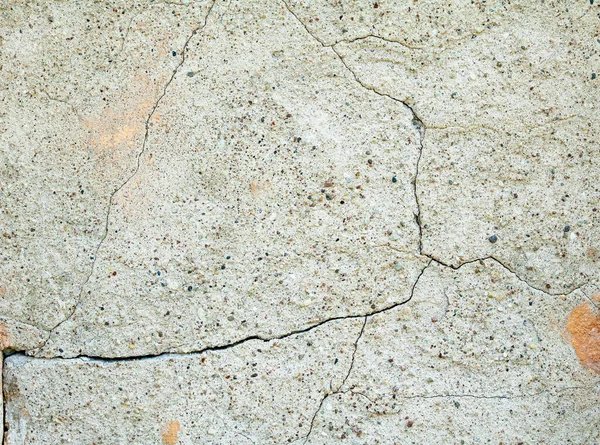 stock image Old wall covered with cement plaster with deep cracks.