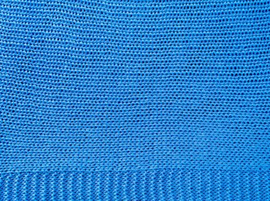 Örülmüş arka plan. Mavi yün ipliklerden örülmüş pürüzlü örgü dokusu..