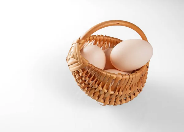 Three Chicken Eggs Small Wicker Basket White Background — Stock Photo, Image