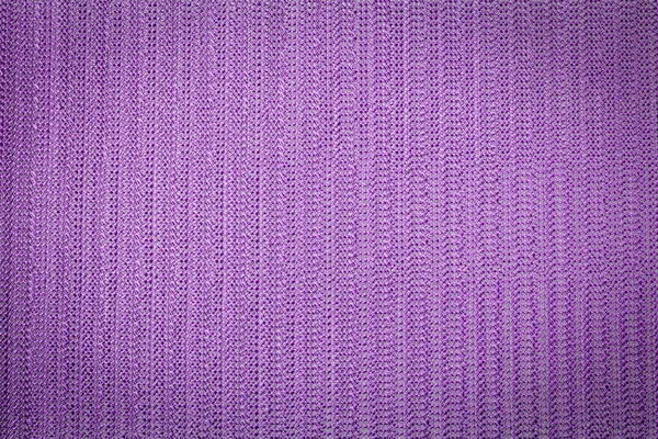 Abstract lavender colored mesh fabric background with vignette top view, macro photography.