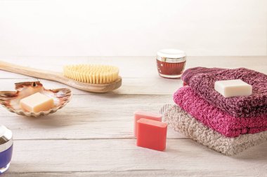 Ahşap bir yüzeye yerleştirilmiş fırça, sabun ve vücut losyonu gibi çeşitli spa aksesuarları. Güzellik ve refah endüstrisi için rahatlama ve kendine bakım konsepti.